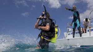 An advanced student learning about diving from a boat