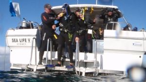 An advanced student learning about diving from a boat